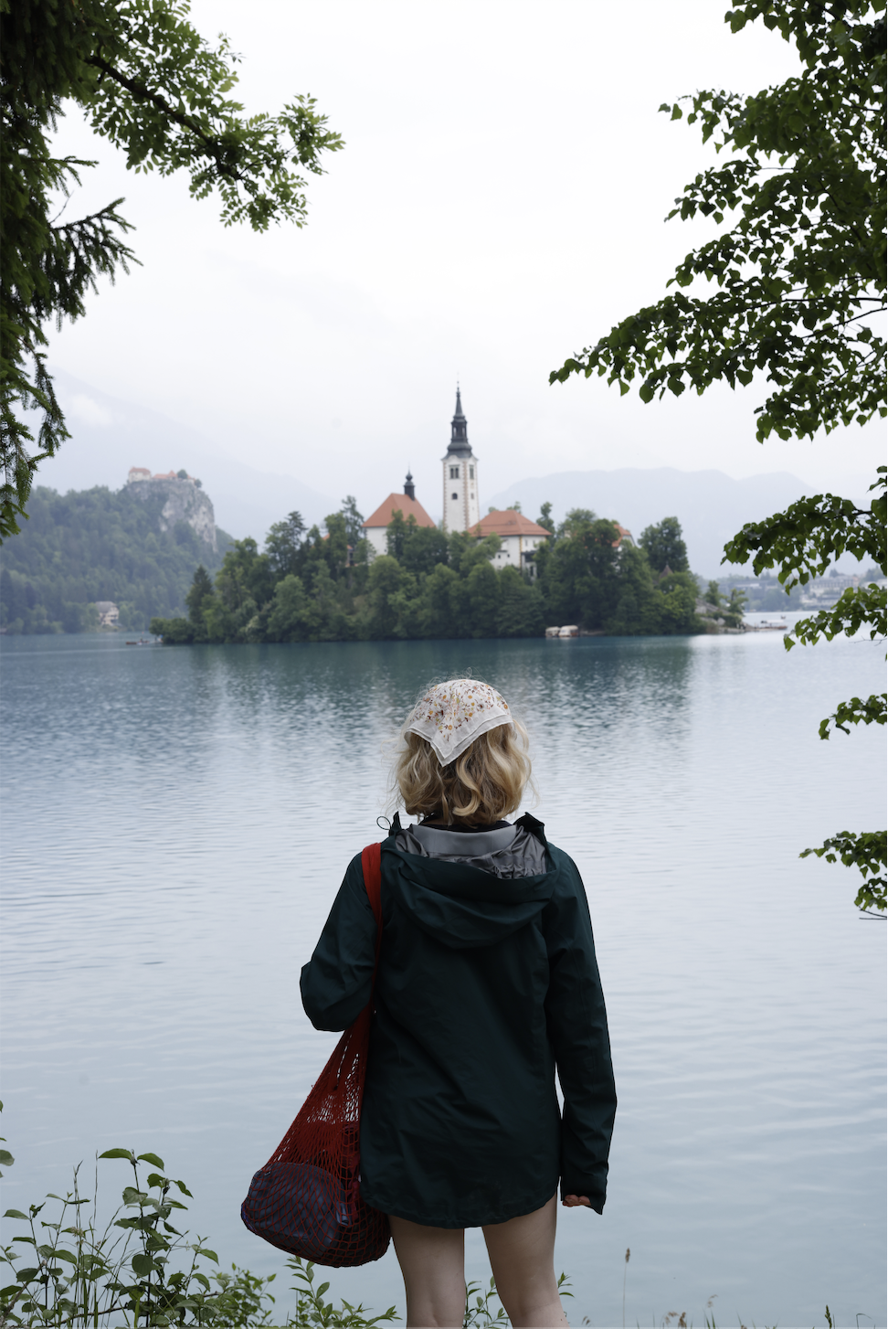 Hannah staring off into the distance across lake Bled.