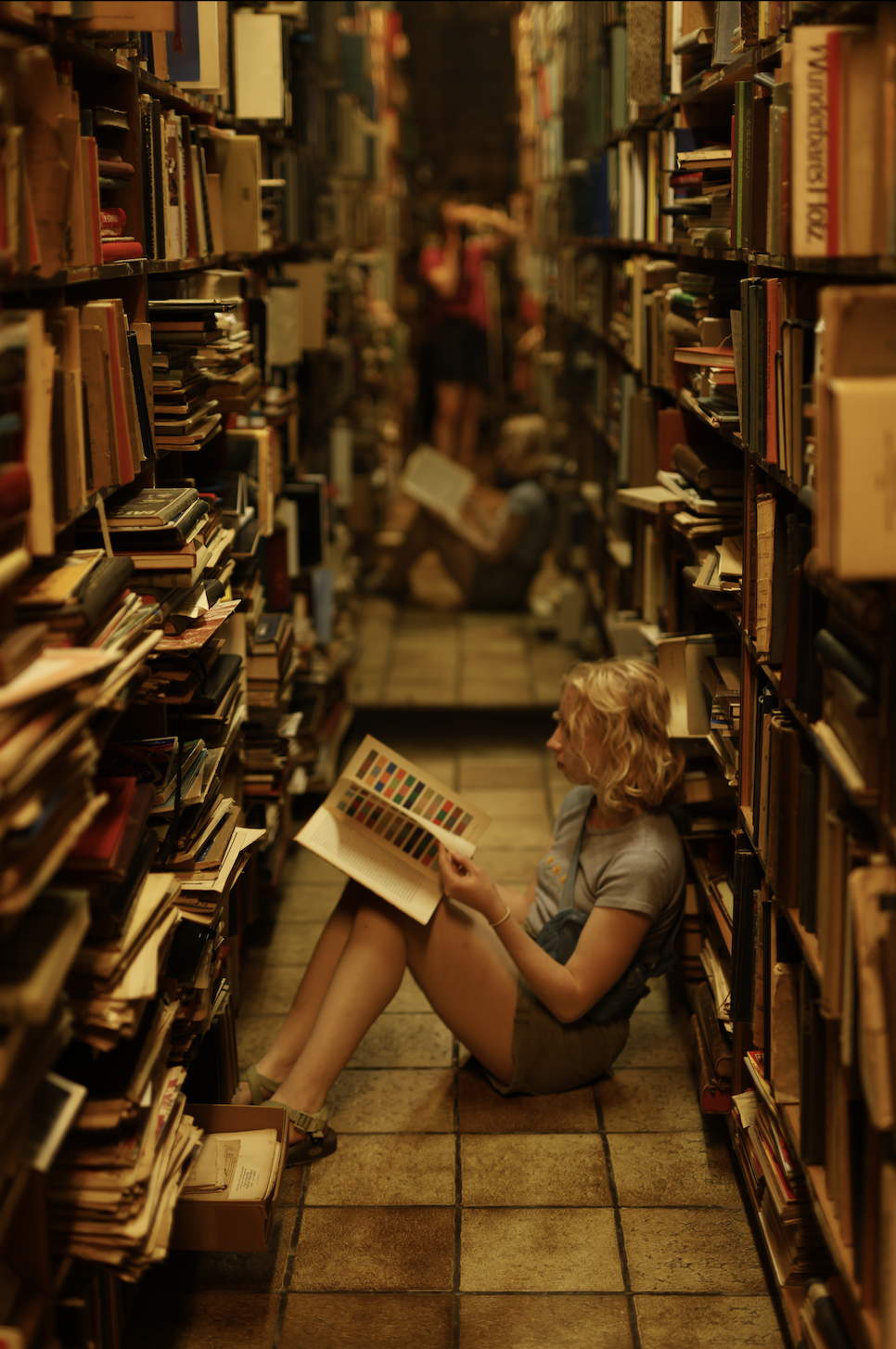 Hannah pretending to read on the floor.